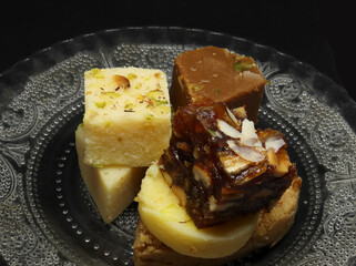 sweets in a plate. on a black background