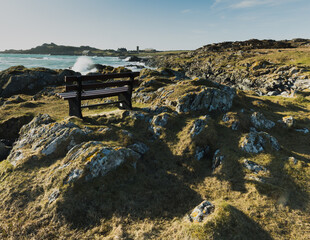 A bench standing over the ocean.