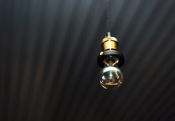 retro light bulb in a dark room with copy space place