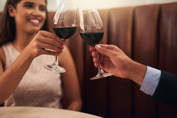 This love is worth toasting to. Cropped shot of a couple making a toast while on a romantic date.