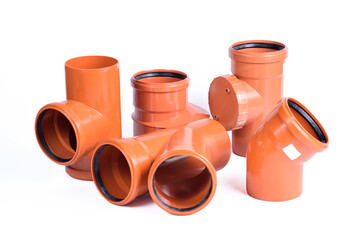 Plumbing fixtures and orange piping parts plastic fittings isolated on a white background