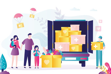 Volunteer distributes boxes of humanitarian aid to poor families. Truck full of crates of refugee essentials