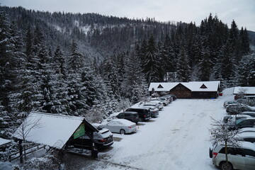 Parking lot with parked cars in the snowy Carpathian mountains