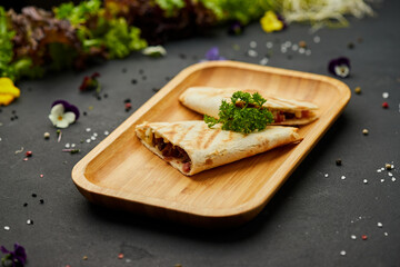 Tasty snacks Tortilla with vegetables and meat. Photo for restaurant menu. Mexican Taco food