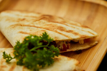 Tasty snacks Tortilla with vegetables and meat. Photo for restaurant menu. Mexican Taco food
