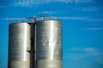 Stainless steel silos in the chemical industry, bulk plastics silo against