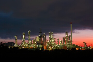 Obraz na płótnie Canvas Oil​ refinery​ and​ plant and tower column of petrochemistry industry in pipeline oil​ and​ gas​ ​industry with​ sun red sky the morning