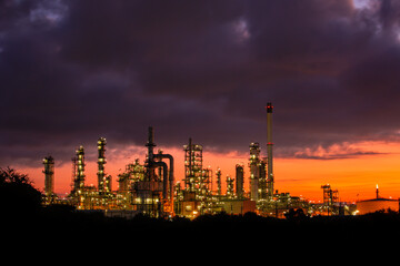 Fototapeta na wymiar Oil​ refinery​ and​ plant and tower column of petrochemistry industry in pipeline oil​ and​ gas​ ​industry with​ sun red sky the morning