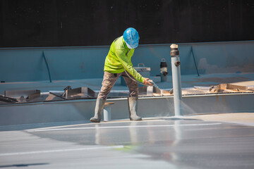 Top view male worker holding an industrial spray gun used for roof plate tank surface on steel industrial painting © chitsanupong