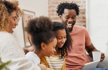 Laughter is what brings us together. Shot of a young family spending time together and using a digital tablet at home.