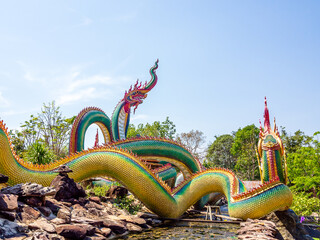 Ubon Ratchathani, THAILAND - February 27, 2022: Buddhist travel . glowing serpent statue with...