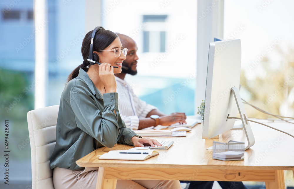 Poster working with the best in the business. shot of two businesspeople working together in a call center.