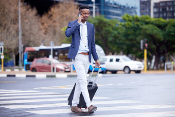 Obraz premium Success is walking from failure to victory. Shot of a young businessman walking and using a phone in the city.