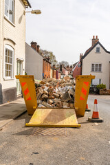 A builders skip containing rubble and bricks from a ongoing home renovation