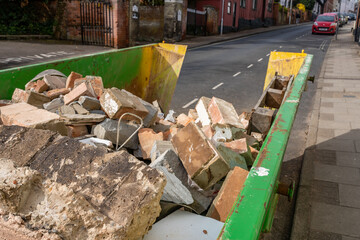 A builders skip containing rubble and bricks from a ongoing home renovation