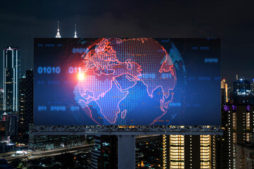 Hologram of Earth planet map on billboard over night panoramic cityscape of Kuala Lumpur, Malaysia, Asia. The concept of international companies in KL. Globe