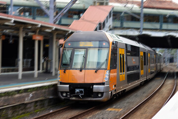 Fototapeta na wymiar Commuter train approaching a train station in Sydney NSW Australia