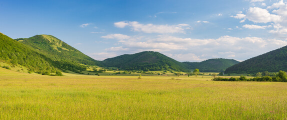Sunset dramatic sky over Montelago highlands, Marche, Italy. Unique hill and mountain green landscape.