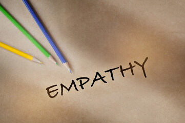 Empathy written on brown paper background with color pencil. Communication with understanding concept and soft skill idea