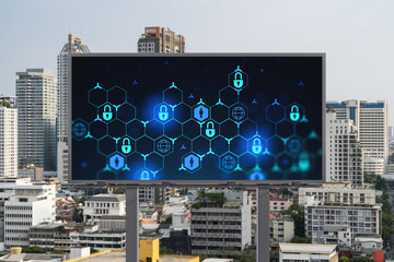 Padlock icon hologram on road billboard over panorama city view of Bangkok at day time to protect business, Southeast Asia. The concept of information security shields.