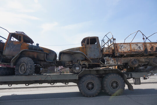 Liquidated Russian Cars Are Transported For Recycling. Damaged Trucks Go For Recycling. Burnt Military Equipment.