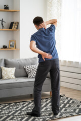 Back pain, man with backache at home