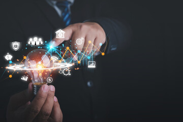 Economic growth graph chart. A business strategy, financial, marketing, and banking. Businessman holding light bulb are planning strategies and analysis profits of a business.