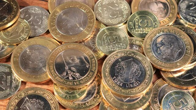 Turkish Lira. Pan shot of freshly minted coin money bunch. Slowly pans in to view on wooden surface. Business and financial for saving or the investment background concept
