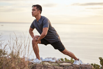 Spending time in nature can be therapeutic. Shot of a young man exercising in nature.