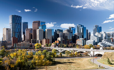 Downtown Calgary skyline in fall colours with office buildings and popular landmarks including the Center street Bridge and Riley park in Alberta Canada.