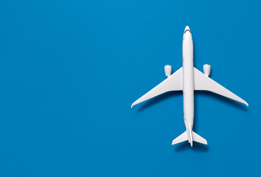 Overhead view of airplane model against blue background