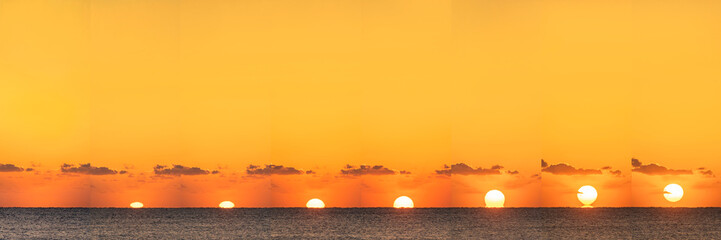 Sequential sun rising above calm ocean