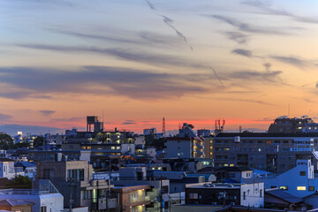 Sunset and clouds over lights of sprawling residential neighborhood