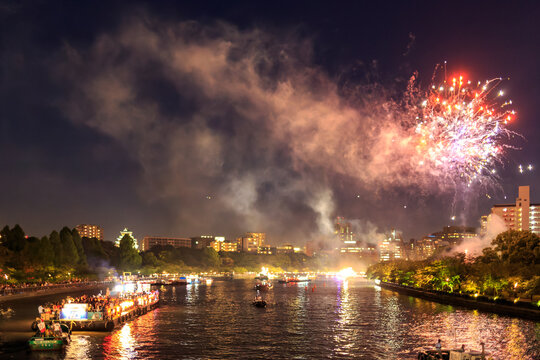 Fireworks and smoke over Tenjin Matsuri celebrations along river in Osaka
