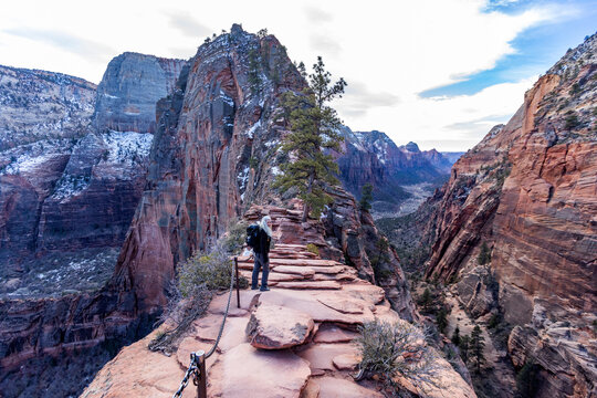 United States, Utah, Zion National Park, Rear view of senior woman hiking on Angels Landing trail in Zion National Park Utah