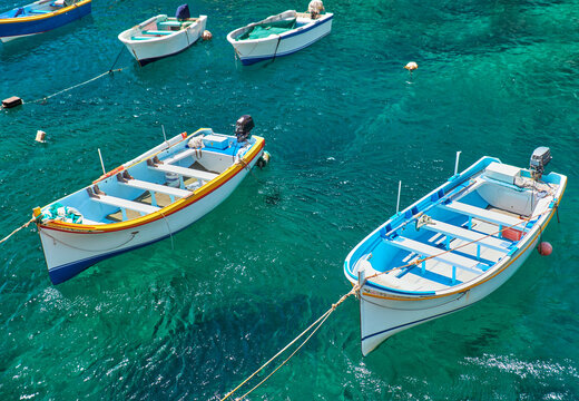 Maltese boats on transparent green water of Wied Zurrieq Fjord of Malta island © Serg Zastavkin