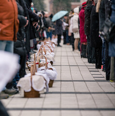 people with food basket waiting for easter blessing