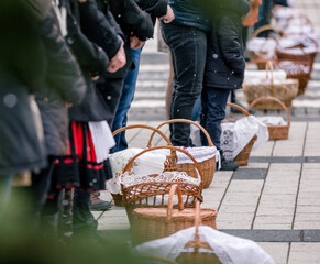 people with food basket waiting for easter blessing