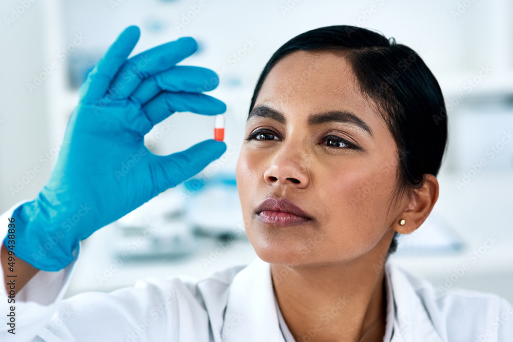 Poster Making sure the tablets ready for use. Cropped shot of an attractive young female scientist inspecting a tablet while working in a laboratory.