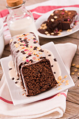 Sponge cake with white frosting and sugars.