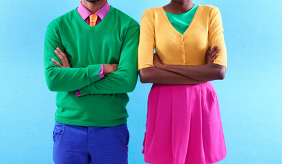 Style with a colorful attitude. Cropped studio shot of a two stylishly dressed people standing with...