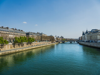 Pedestrian walkway on the Seine river bank with Pont au Change and Louvre palace