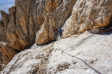 a mountaineer male is climbing on the stone rock