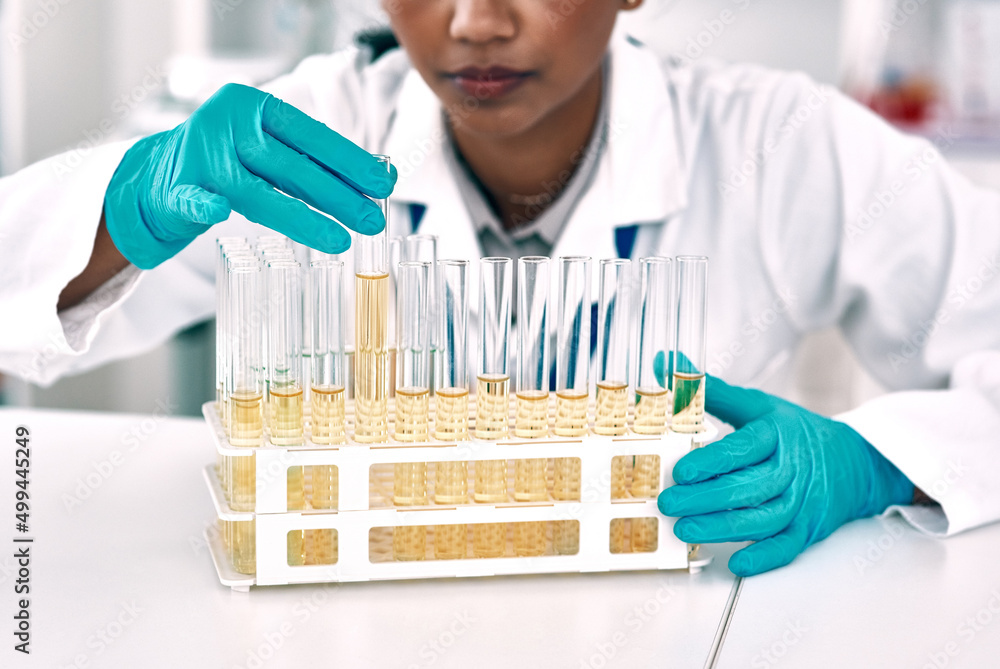 Aufkleber The experiment with the gold liquids.... Cropped shot of an unrecognizable female scientist conducting an experiment with a tray of test tubes in a laboratory.