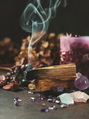 Palo Santo, holy sacred tree stick, burning with aroma smoke. Esoteric life balance, good energy concept. Healing energy with crystals and smoke.