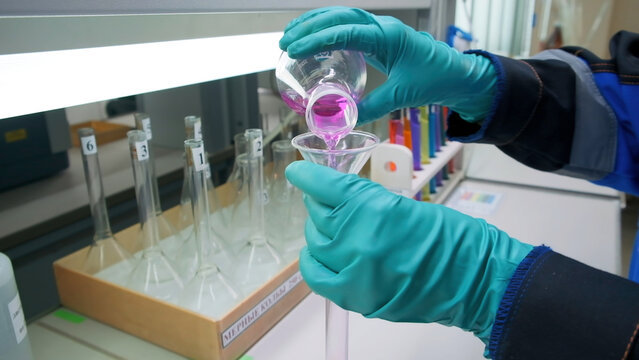A sign warning of danger. Clip. People performing work in a dangerous area going to a gas mask on the background of a sign warning of danger