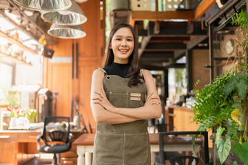 portrait of asian adult female woman wear apron standing at entrance of her workshop pottery studio incasual cloth relax smiling confident and warm welcome,asian woman with her home studio workshop