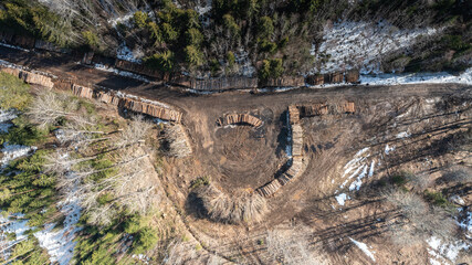 Aerial view to the woodland, badly suffered from unsustainable forest cutting and forest soil destruction by using heavy machinery during the non-frozen season