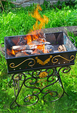 Lighting a fire in a metal grill for cooking kebabs and steaks