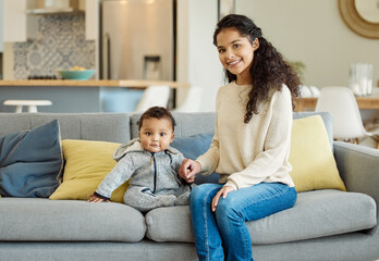 Hes the sweetest little boy. Shot of a young mother bonding with her baby boy on the sofa at home.